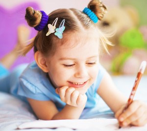 Happy cute girl painting in her room